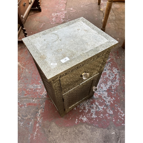 124 - A Middle Eastern embossed metal bedside cabinet - approx. 66cm high x 40cm wide x 30cm deep