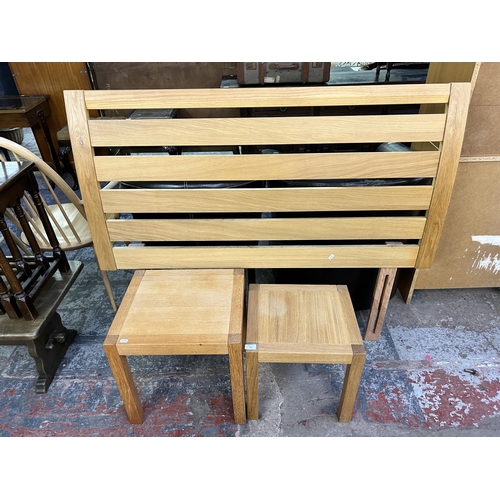 133 - Three pieces of modern oak furniture, two side tables and one bed headboard - approx. 139cm wide