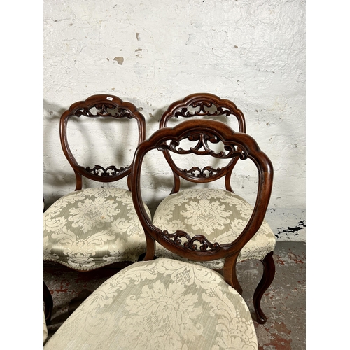 134 - Five Victorian carved mahogany and floral upholstered balloon back dining chairs