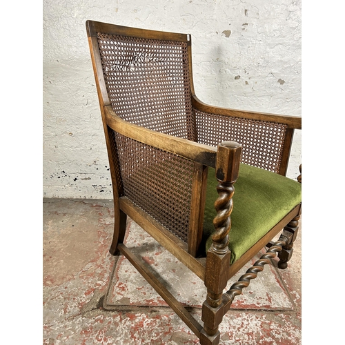 135 - A mid 20th century beech and rattan bergère chair on barley twist supports