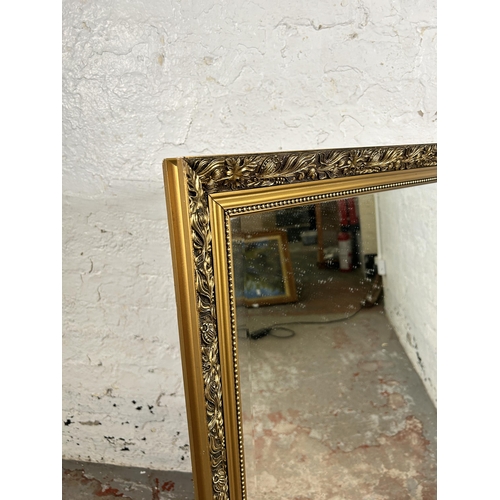 138 - A 19th century style gilt framed bevelled edge wall mirror - approx. 71cm high x 97cm wide
