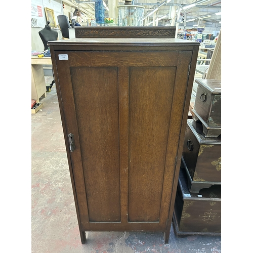 139 - A mid 20th century carved oak bedroom cabinet with internal drawer - approx. 138cm high x 62cm wide ... 