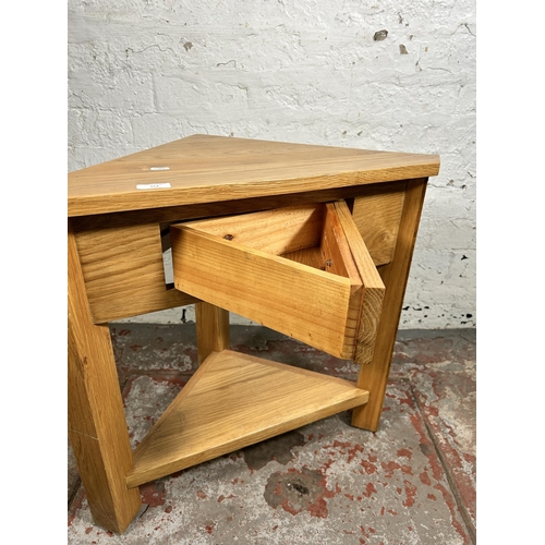 154 - A modern solid oak single drawer corner occasional table - approx. 60cm high x 65cm wide x 38cm deep