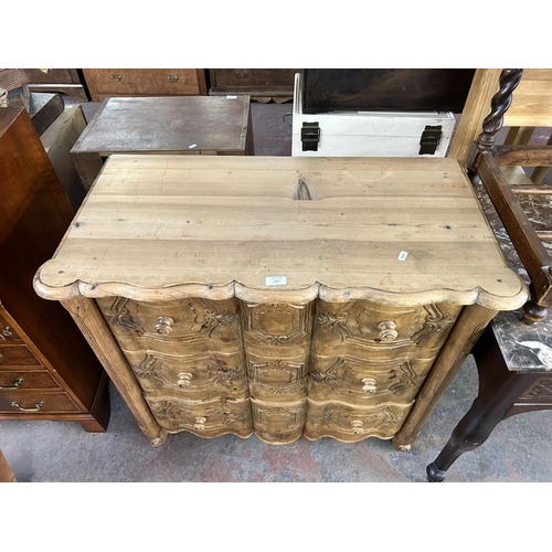 167 - A French carved pine serpentine chest of drawers - approx. 86cm high x 91cm wide x 45cm deep