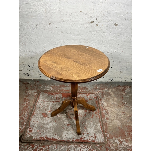169 - A 19th century style beech circular pedestal side table - approx. 68cm high x 50cm in diameter