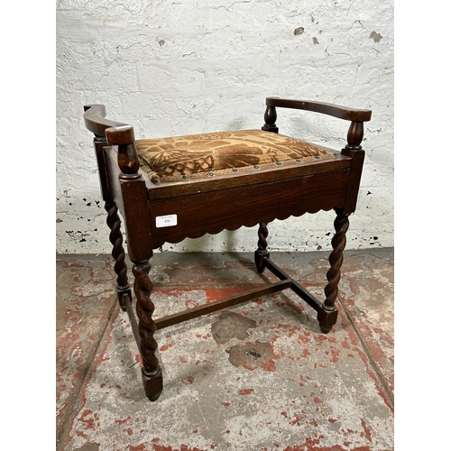 173 - An early/mid 20th century oak and fabric upholstered barley twist piano stool