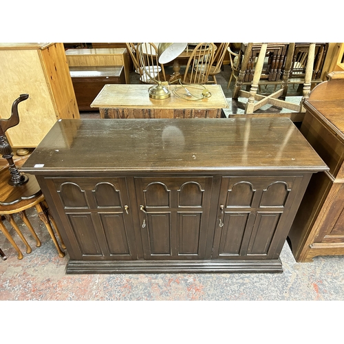 175 - A mid/late 20th century oak three door sideboard with fitted interior - approx. 86cm high x 140cm wi... 