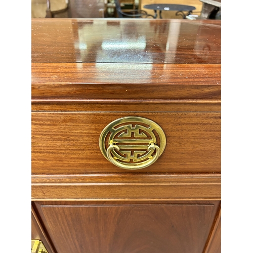 181 - A Chinese carved hardwood sideboard - approx. 88cm high x 124cm wide x 46cm deep