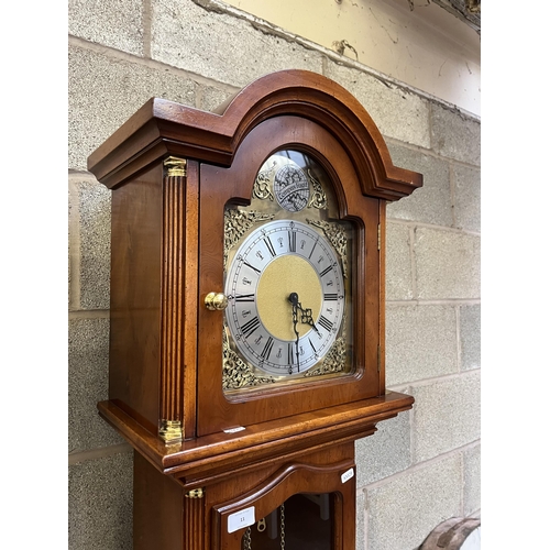 11 - A yew wood cased grandfather clock with brass Tempus Fugit face, pendulum and weights - approx. 196c... 
