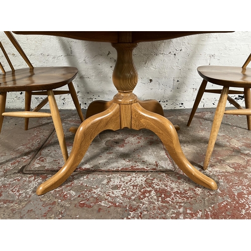 112 - An Ercol Windsor blonde elm and beech oval extending dining table and four Quaker dining chairs - ap... 