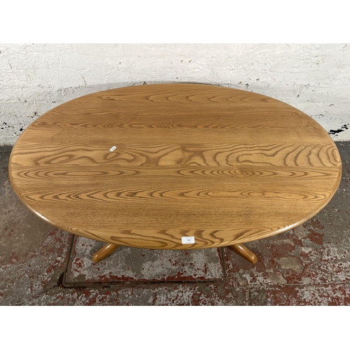 114 - An Ercol Windsor blonde elm and beech oval pedestal coffee table - approx. 51cm high x 77cm wide x 1... 