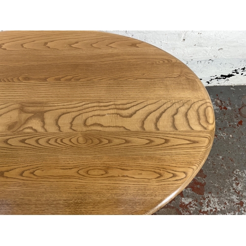 114 - An Ercol Windsor blonde elm and beech oval pedestal coffee table - approx. 51cm high x 77cm wide x 1... 