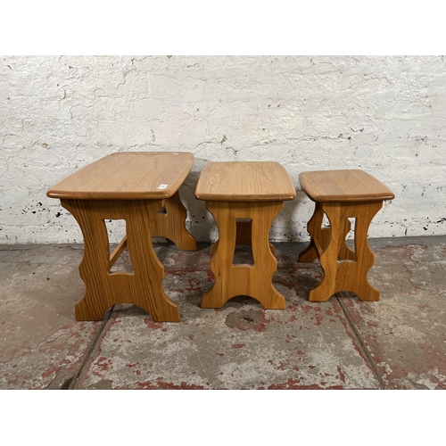 115 - An Ercol Windsor blonde elm nest of tables - approx. 42cm high x 57cm wide x 35cm deep