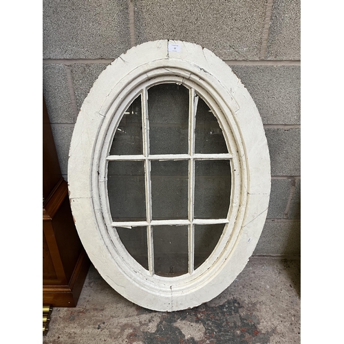 12 - An antique white painted pine framed oval window - approx. 104cm high x 72cm wide