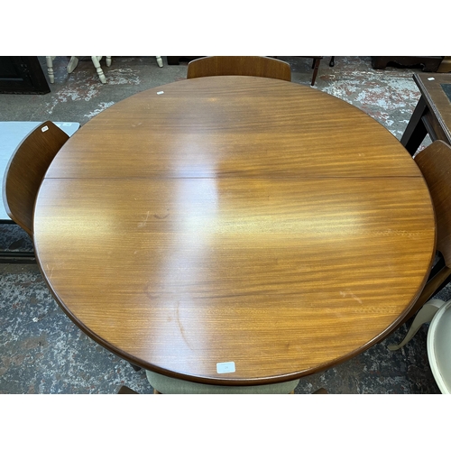 24 - A mid 20th century Elliotts of Newbury (EON) teak circular extending dining table and four chairs - ... 