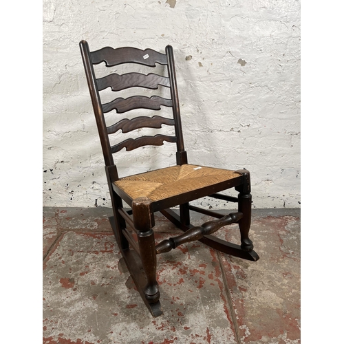 36 - A 19th century style elm and rush seated rocking chair