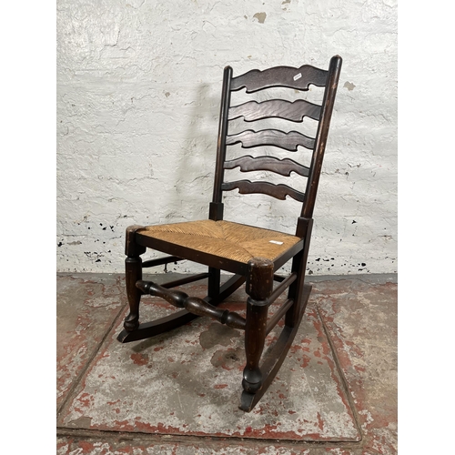 36 - A 19th century style elm and rush seated rocking chair