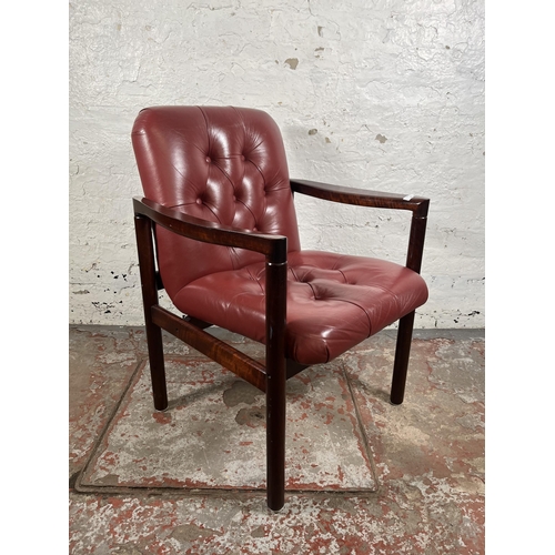 45 - A mid 20th century rosewood effect and red leather armchair