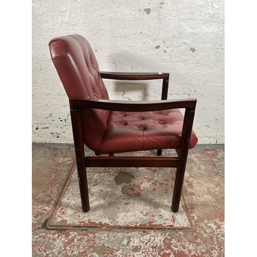 45 - A mid 20th century rosewood effect and red leather armchair