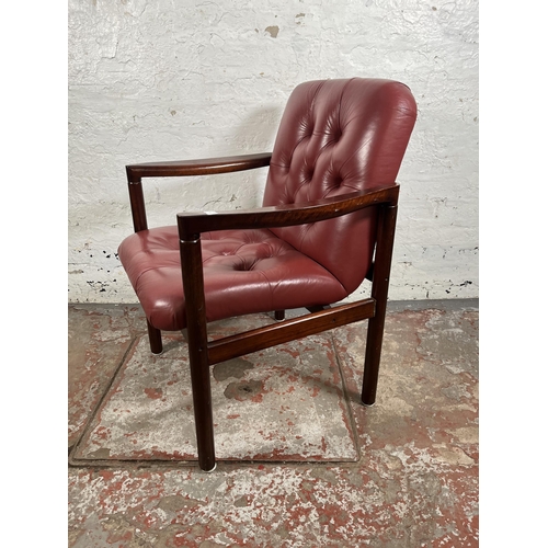 45 - A mid 20th century rosewood effect and red leather armchair