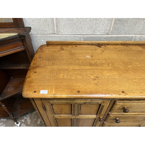 5 - An Ercol Old Colonial elm sideboard - approx. 92cm high x 146cm wide x 51cm deep