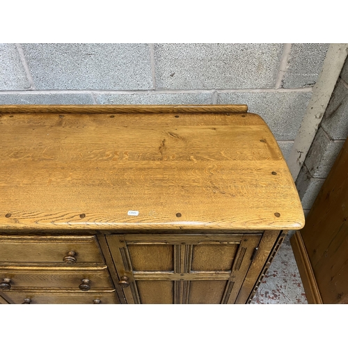 5 - An Ercol Old Colonial elm sideboard - approx. 92cm high x 146cm wide x 51cm deep