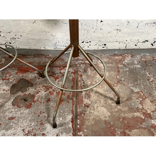 56 - A pair of mid 20th century brown vinyl and tubular metal swivel bar stools - approx. 94cm high