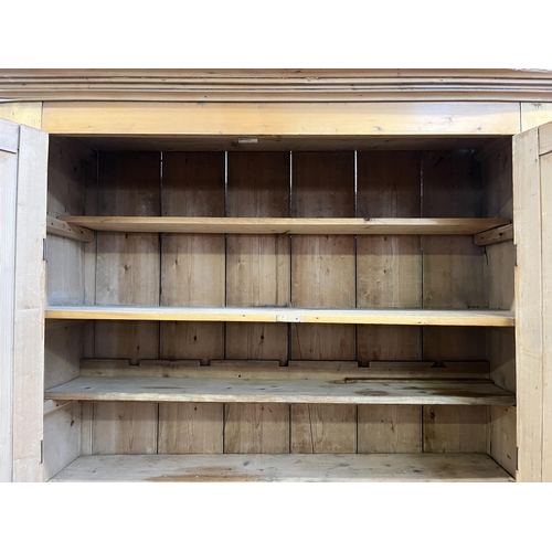 6 - A Victorian pine four door housekeeper's cupboard - approx. 218cm high x 140cm wide x 51cm deep