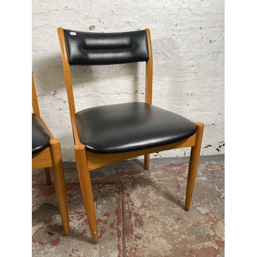 70 - A pair of mid 20th century beech and black vinyl dining chairs