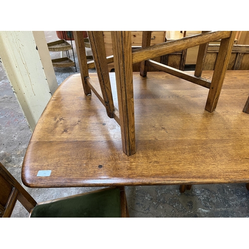 71 - An Ercol Old Colonial elm dining table and six chairs - approx. 72cm high x 74cm wide x 152cm long