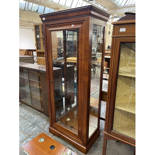 76 - A French cherrywood and glass single door display cabinet with three glass shelves - approx. 162cm h... 