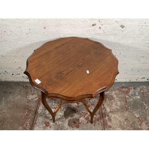 79 - An Edwardian walnut serpentine two tier side table - approx. 70cm x 66cm in diameter