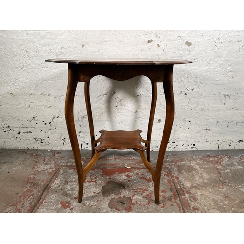 79 - An Edwardian walnut serpentine two tier side table - approx. 70cm x 66cm in diameter