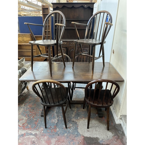 87 - A mid 20th century Ercol dark elm and beech dining table and six chairs