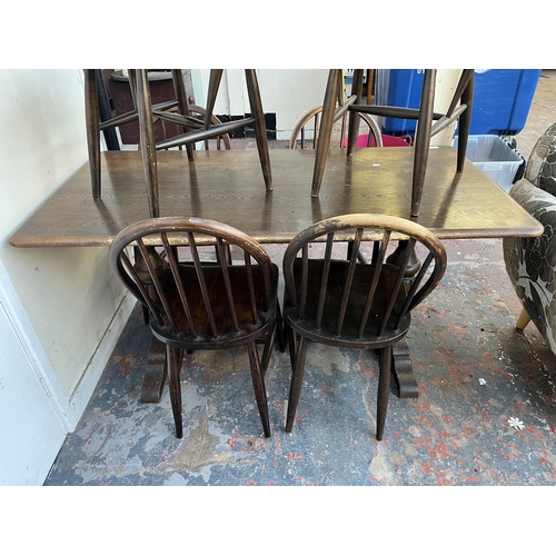 87 - A mid 20th century Ercol dark elm and beech dining table and six chairs