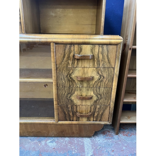 91 - An Art Deco walnut drinks cabinet with two glass sliding doors and fall front - approx. 106cm high x... 