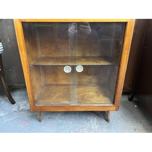 93 - A mid 20th century plywood bureau bookcase with glass sliding doors