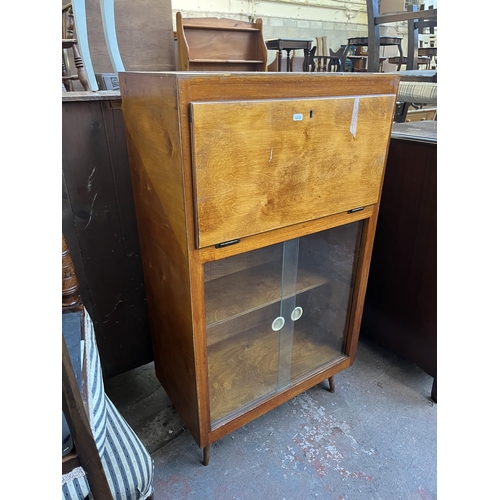 93 - A mid 20th century plywood bureau bookcase with glass sliding doors