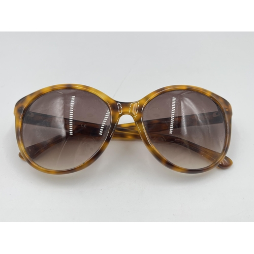 2175 - A pair of Calvin Klein tortoiseshell effect lady's sunglasses