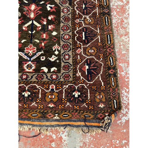 143 - A Persian hand knotted rug - approx. 140cm x 83cm