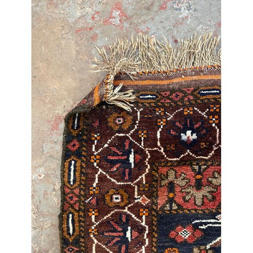 143 - A Persian hand knotted rug - approx. 140cm x 83cm