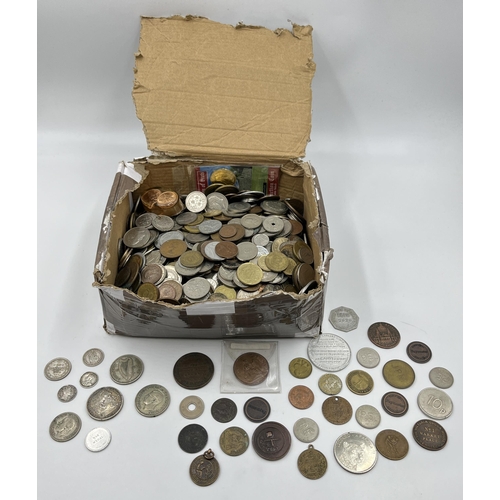 2208 - A collection of tokens and world coins with silver examples to include 50% 1903 Russian twenty kopec... 