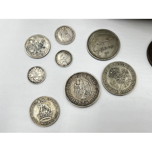 2208 - A collection of tokens and world coins with silver examples to include 50% 1903 Russian twenty kopec... 