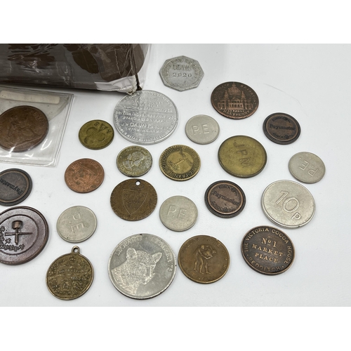 2208 - A collection of tokens and world coins with silver examples to include 50% 1903 Russian twenty kopec... 