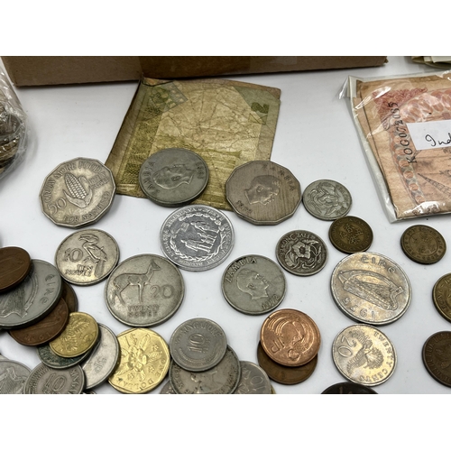 2212 - A collection of world banknotes and coins to include 50% silver 1963 Australian sixpence etc.