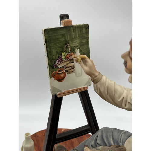 288 - A Capodimonte porcelain figurine of an artist painting a still life scene - approx. 29cm high