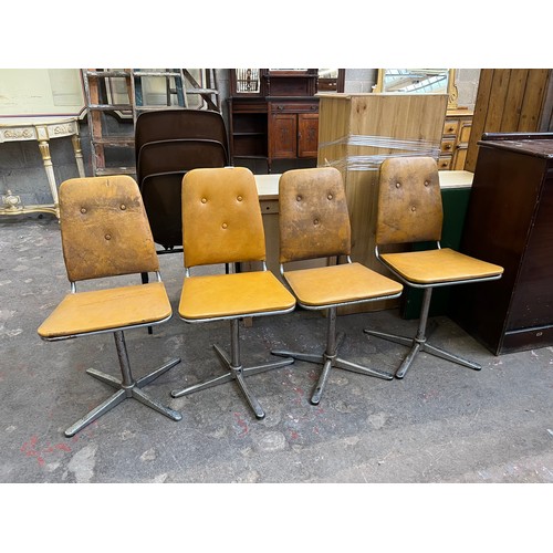29 - Four 1960s mustard yellow vinyl and chrome plated swivel dining chairs