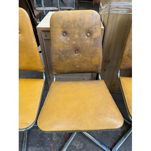 29 - Four 1960s mustard yellow vinyl and chrome plated swivel dining chairs