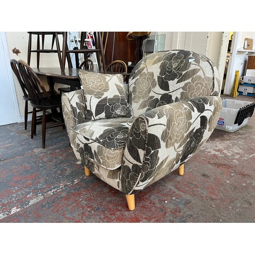 88 - A modern brown and cream floral fabric upholstered armchair