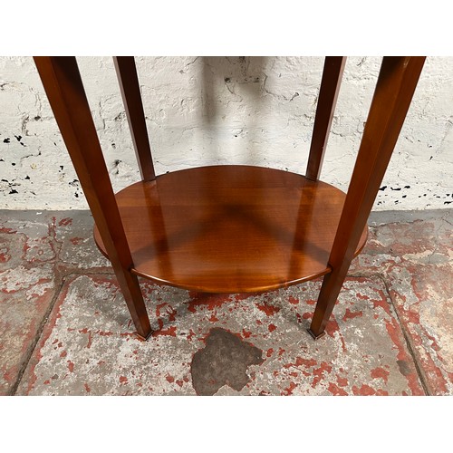 108 - A Grange mahogany oval two tier side table - approx. 64cm high x 57cm wide x 41cm deep